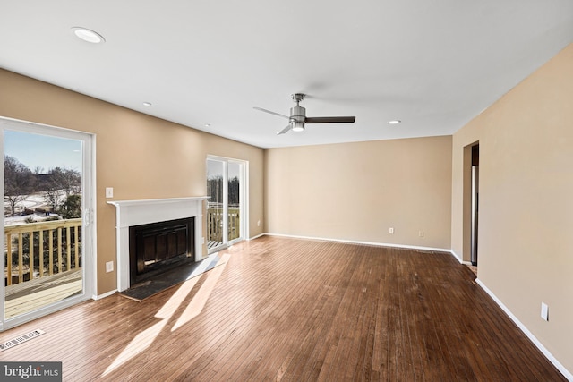 unfurnished living room with hardwood / wood-style flooring and ceiling fan