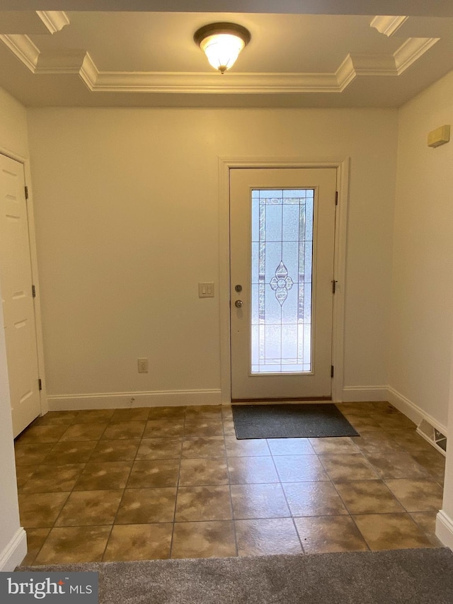 entryway featuring dark tile patterned flooring, crown molding, and a raised ceiling