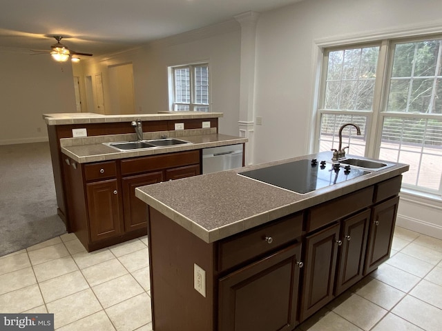 kitchen with dishwasher, a kitchen island with sink, sink, and dark brown cabinetry