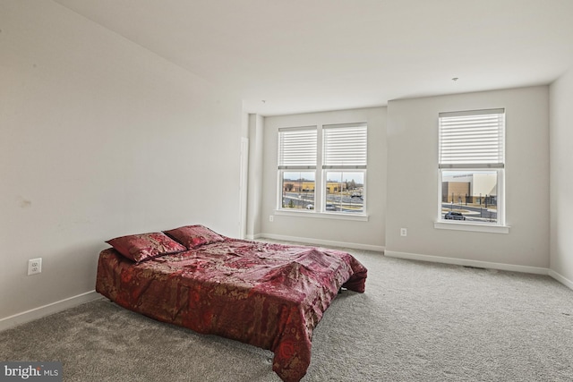 bedroom with carpet flooring and baseboards