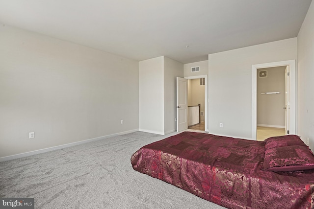 bedroom with light carpet, baseboards, and visible vents