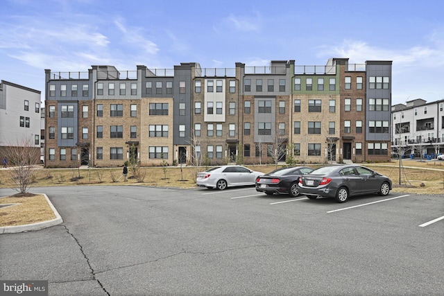 view of property featuring uncovered parking