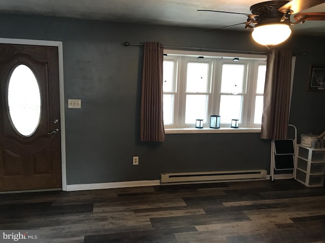 foyer featuring ceiling fan, dark wood-type flooring, a baseboard radiator, and a healthy amount of sunlight