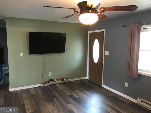 foyer entrance with dark wood-type flooring, a baseboard radiator, and ceiling fan