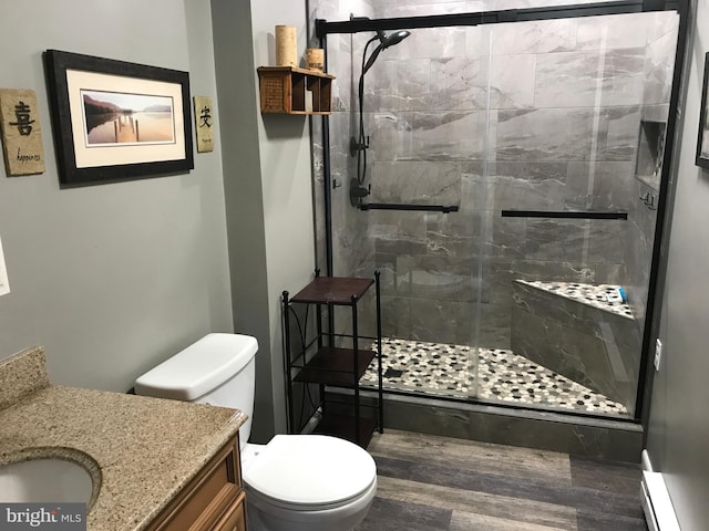 bathroom with vanity, a shower with shower door, and toilet