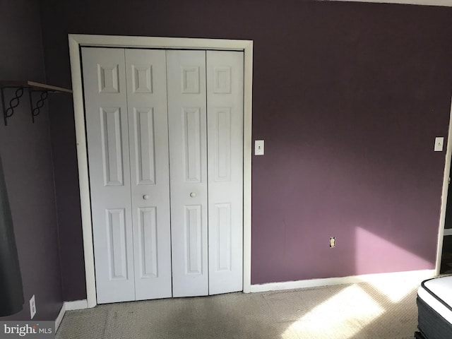 unfurnished bedroom with carpet floors and a closet