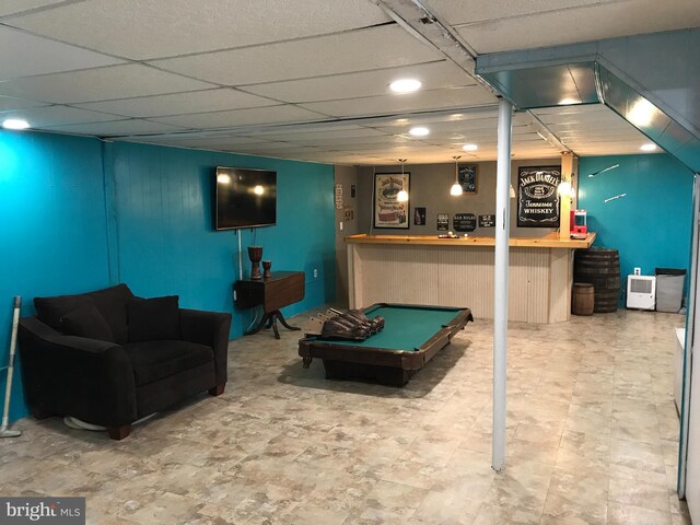 game room with a drop ceiling, bar area, and billiards