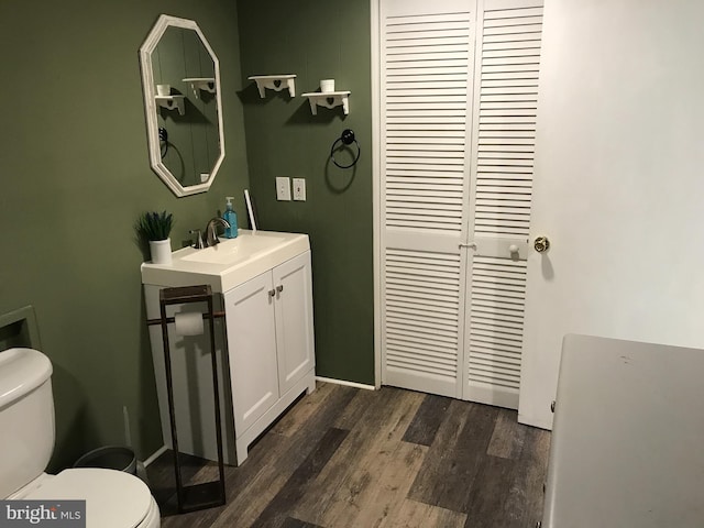 bathroom featuring hardwood / wood-style flooring, vanity, and toilet