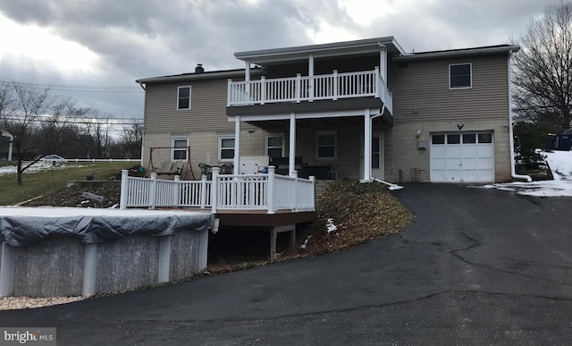 view of front of property with a garage and a balcony