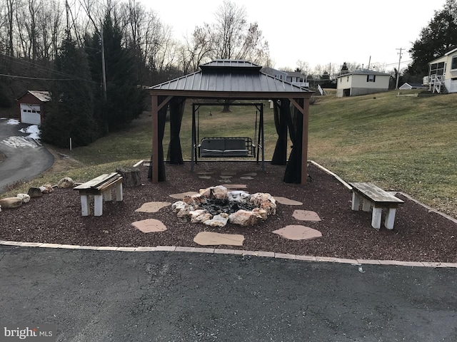 view of yard featuring a gazebo and a fire pit