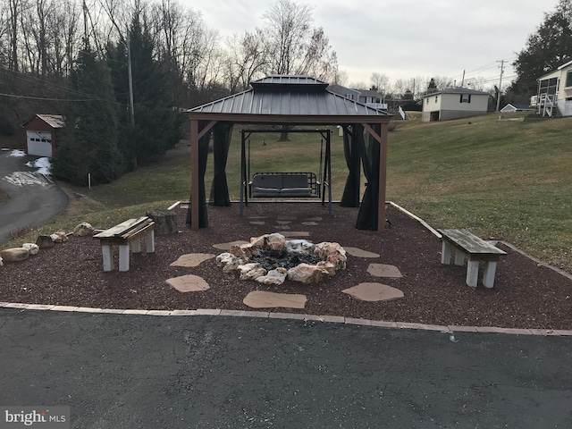 view of yard featuring a fire pit and a gazebo