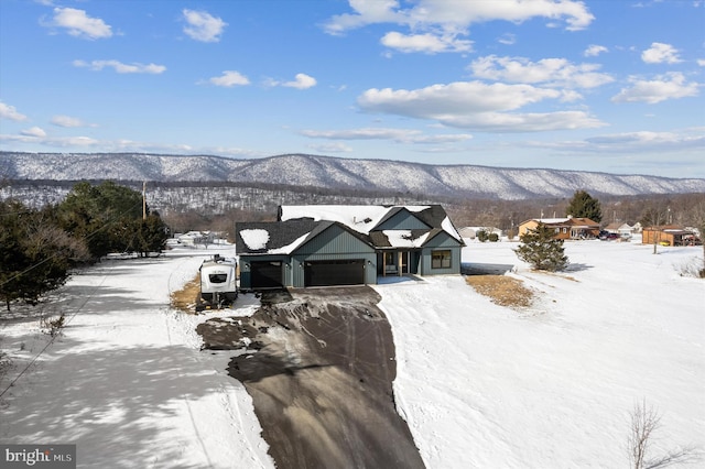 view of front of house featuring a garage and a mountain view