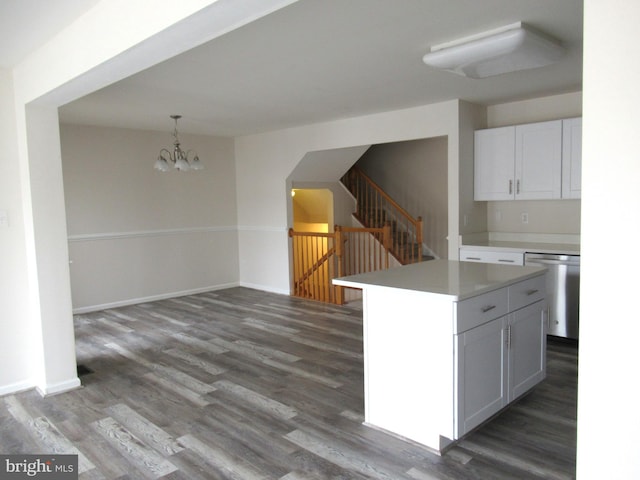 kitchen featuring white cabinetry, an inviting chandelier, dishwasher, a kitchen island, and pendant lighting