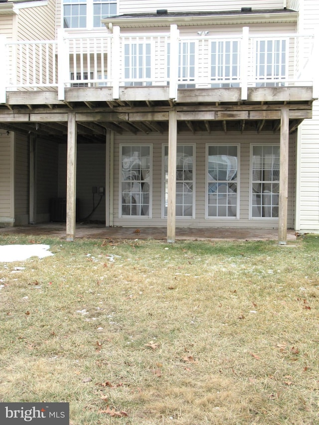 rear view of property with a lawn