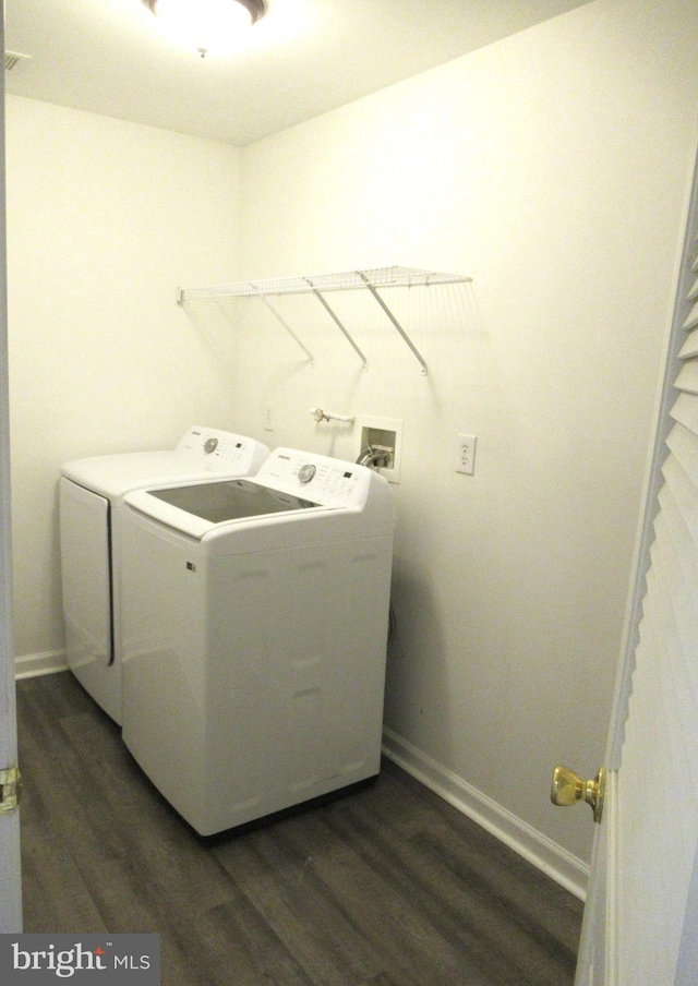 washroom with dark hardwood / wood-style floors and separate washer and dryer