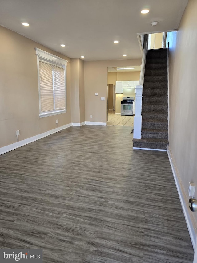 unfurnished living room featuring dark wood-type flooring