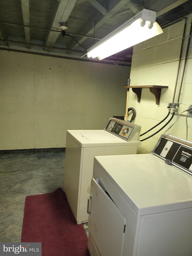 clothes washing area with separate washer and dryer