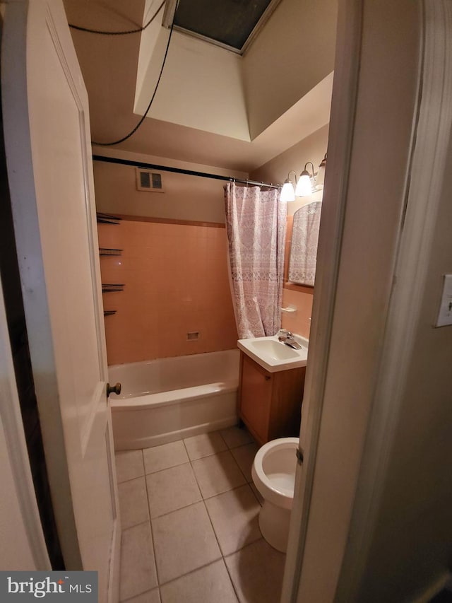 full bathroom with vanity, toilet, tile patterned flooring, and shower / bath combo with shower curtain