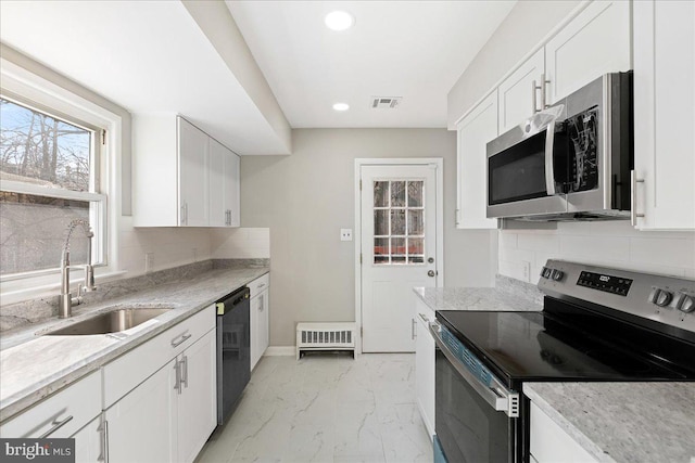 kitchen featuring a sink, visible vents, white cabinetry, marble finish floor, and appliances with stainless steel finishes