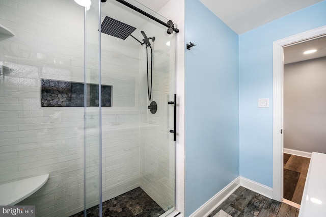 bathroom featuring wood-type flooring and walk in shower