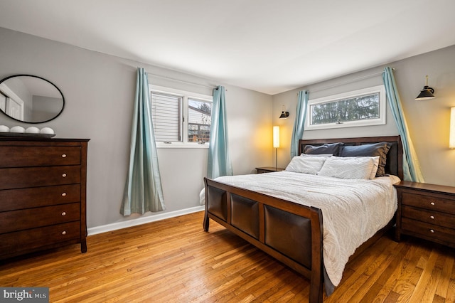 bedroom featuring multiple windows and light hardwood / wood-style flooring