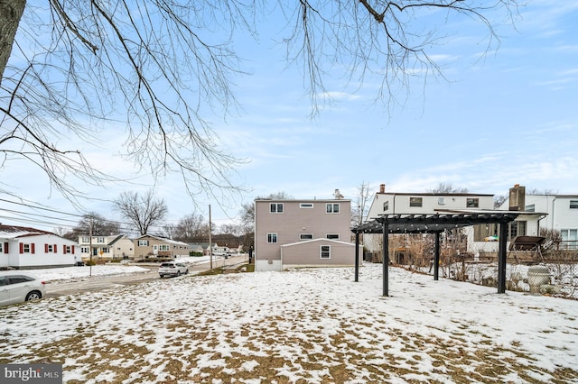 snowy yard with a pergola