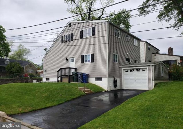 view of side of home with a garage and a lawn