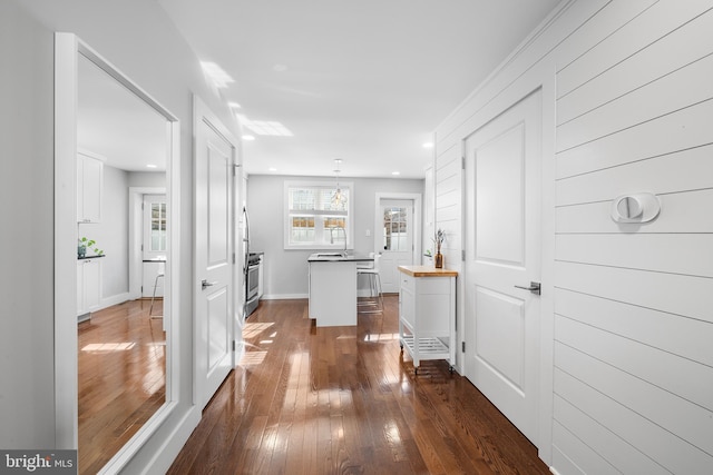 hallway with dark hardwood / wood-style floors and sink