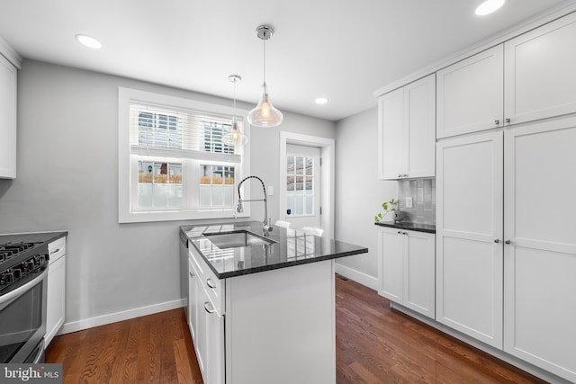 kitchen featuring sink, gas range, and white cabinets