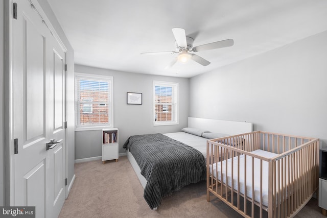 bedroom with light colored carpet and ceiling fan