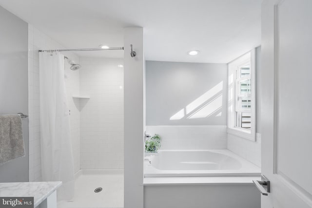 bathroom with vanity and independent shower and bath