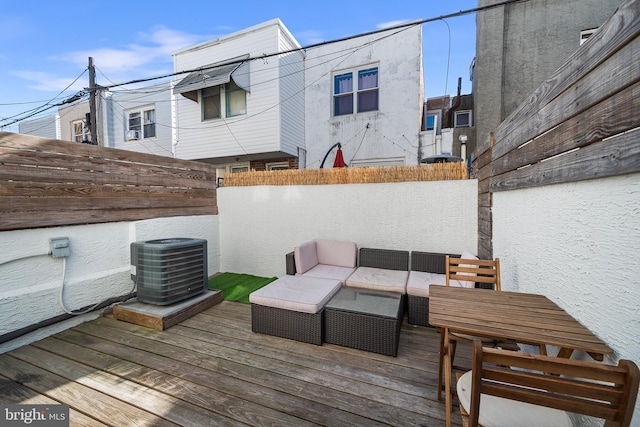 wooden terrace featuring outdoor lounge area and central AC unit