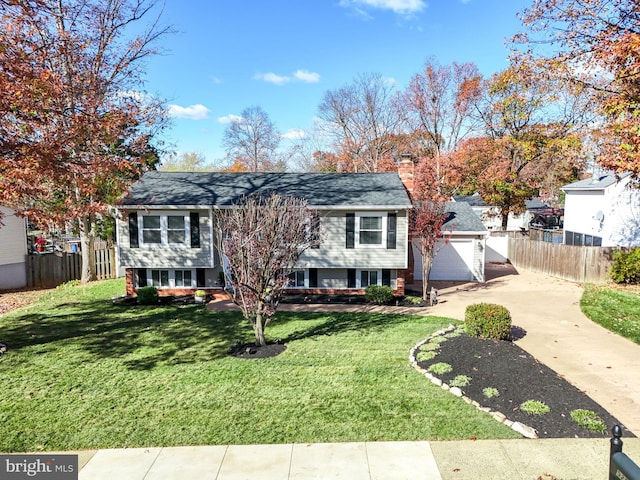 raised ranch with a garage and a front lawn