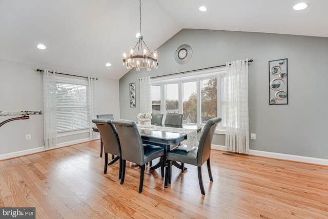 dining space featuring lofted ceiling and light hardwood / wood-style floors