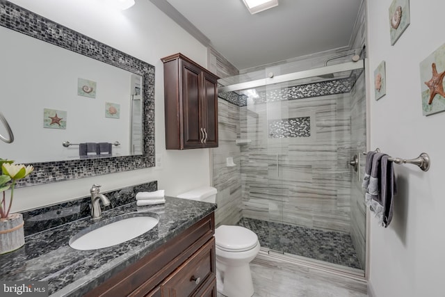 bathroom with vanity, toilet, and an enclosed shower