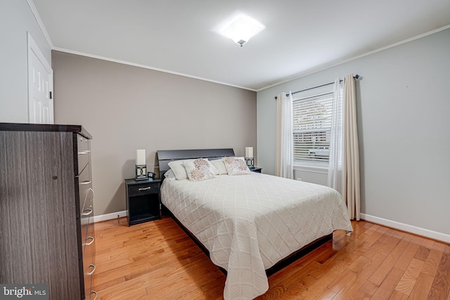 bedroom with crown molding and light wood-type flooring