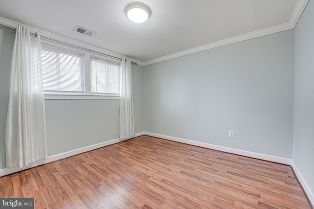 unfurnished room with ornamental molding and light hardwood / wood-style flooring