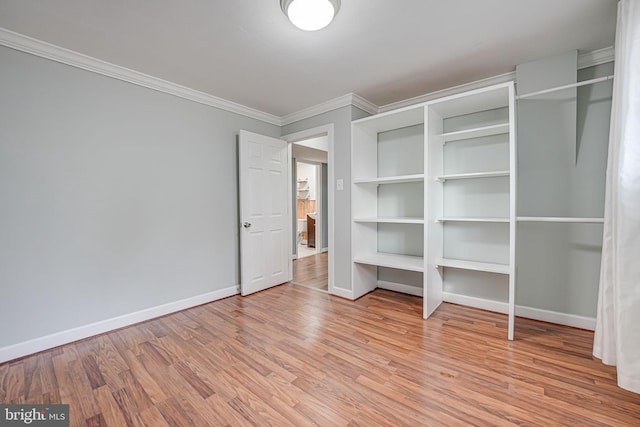 unfurnished bedroom featuring crown molding and light hardwood / wood-style floors