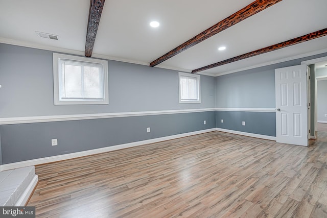 basement with light hardwood / wood-style floors and a healthy amount of sunlight