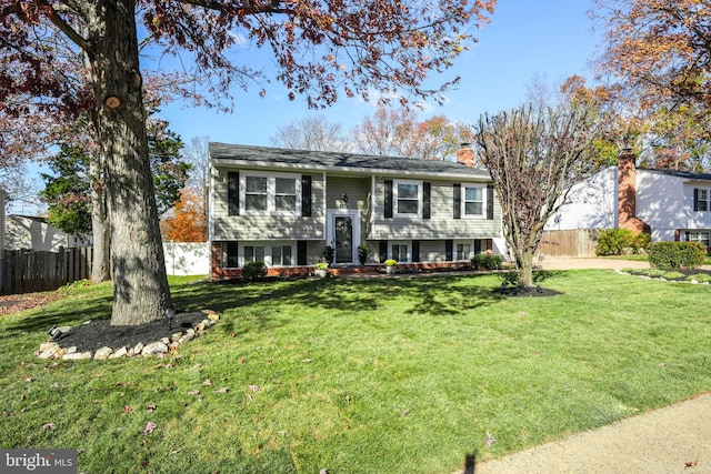 bi-level home with a front lawn