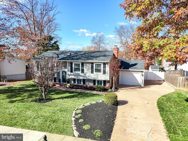 view of front of home with a garage and a front lawn