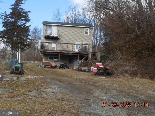 rear view of house featuring a deck