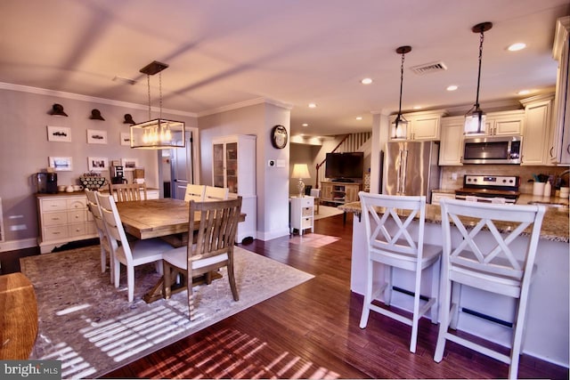 dining room with crown molding, dark hardwood / wood-style flooring, and sink