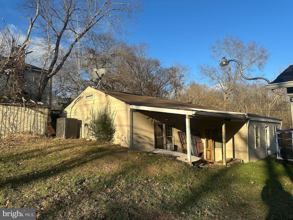 rear view of house featuring a yard