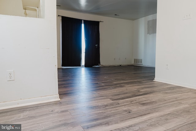 spare room with wood-type flooring