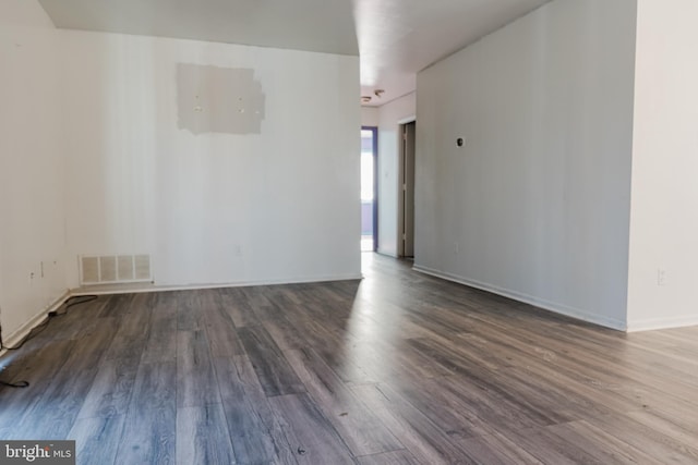 unfurnished room with hardwood / wood-style flooring