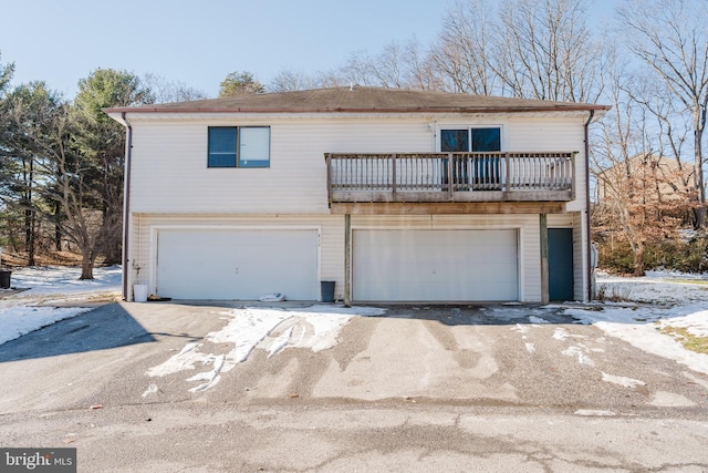 front facade featuring a balcony and a garage