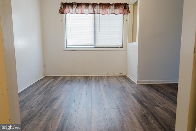 empty room featuring dark hardwood / wood-style flooring