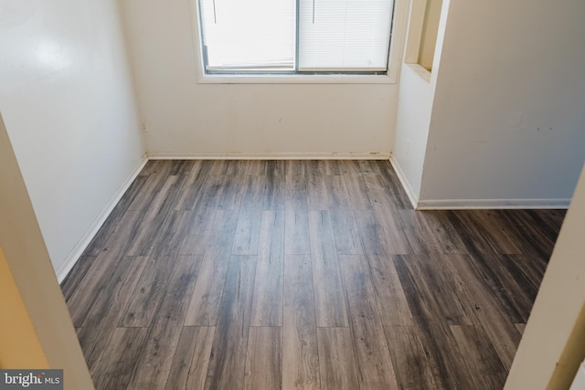 unfurnished room featuring dark wood-type flooring