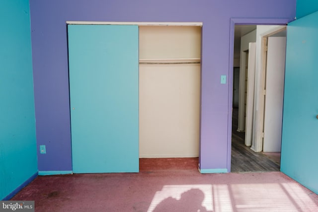 unfurnished bedroom featuring carpet and a closet